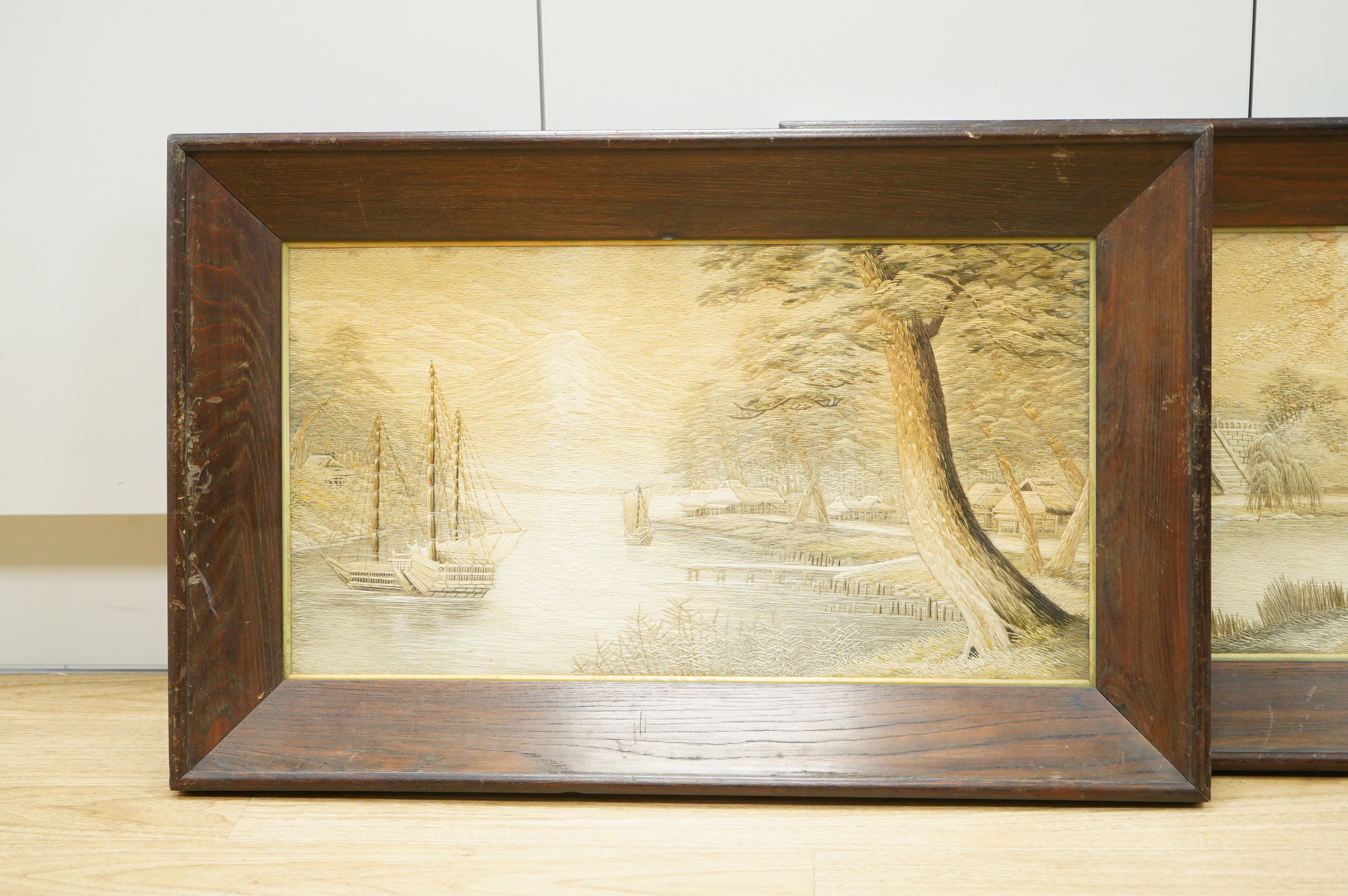 A pair of Japanese silk embroidered framed panels, 30 x 55cm